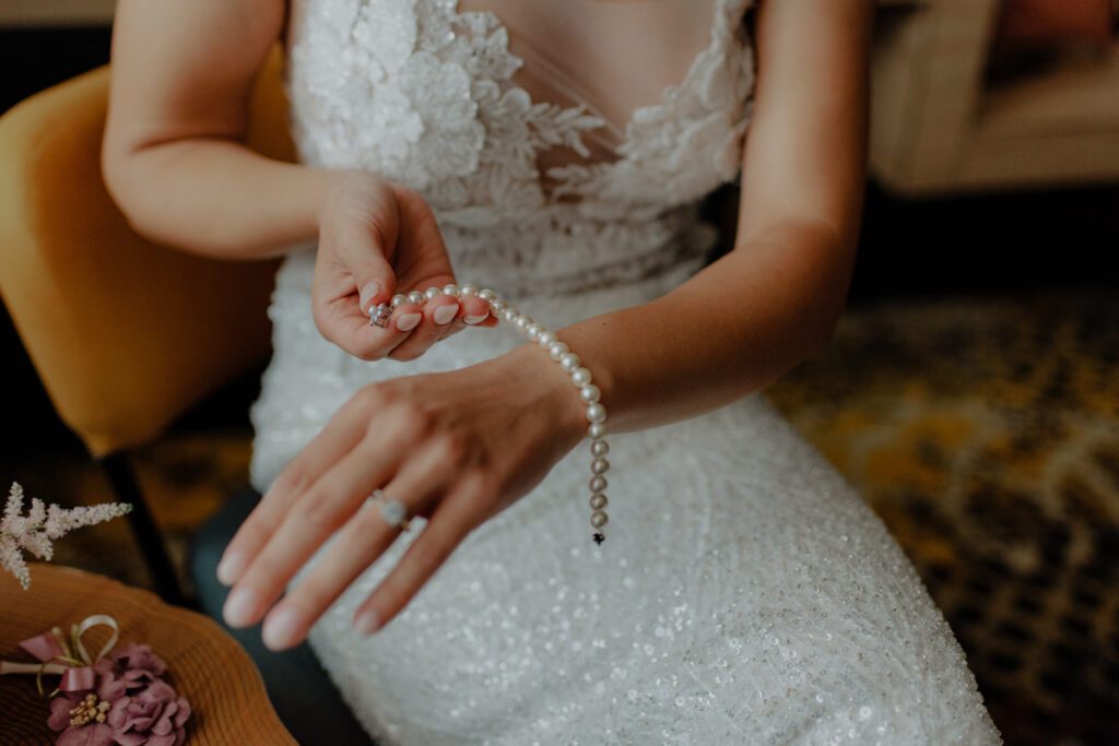bride wearing a pearl bracelet on her wrist 2023 11 27 05 28 01 utc